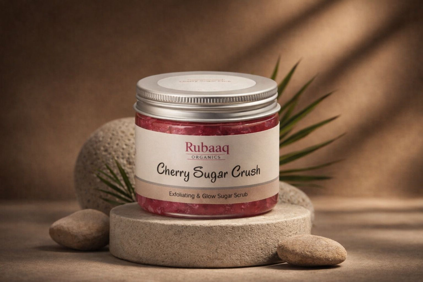 Rubaaq Cherry Sugar Crush sugar scrub jar on a stone surface with a brown background