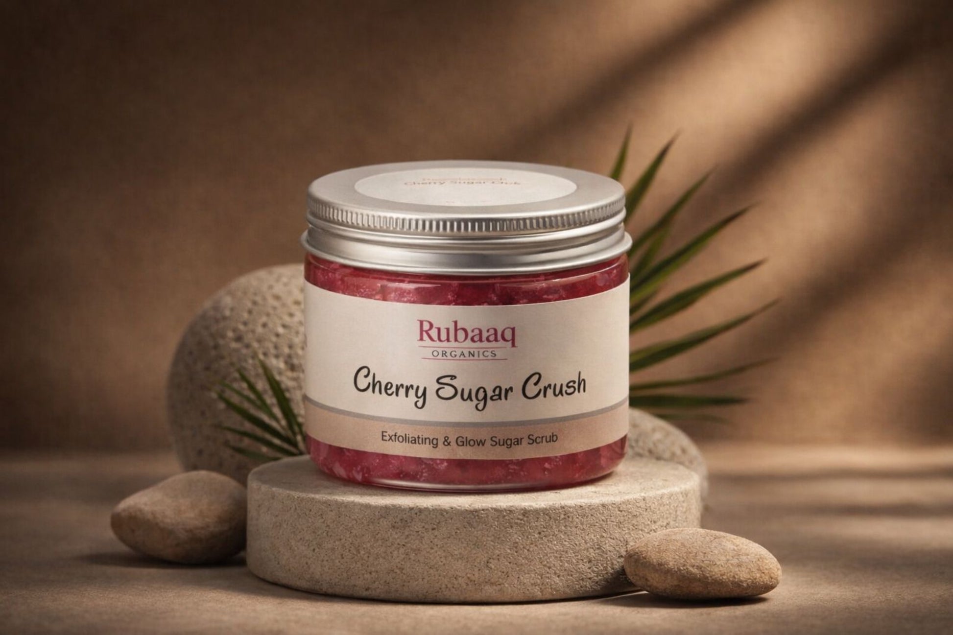 Rubaaq Cherry Sugar Crush sugar scrub jar on a stone surface with a brown background